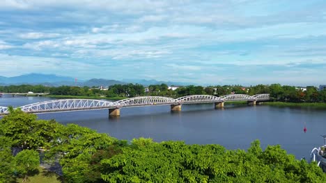 aerial revealing shot of the truong tien bridge over the perfume river in hue