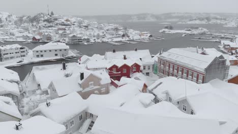 kragero, telemark county, norway - a charming town draped in snow on a wintry day - aerial pullback shot