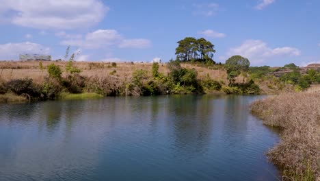 calm lake water with reflection and dramatic blue sky at morning