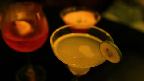 colorful cocktails on a dimly lit table