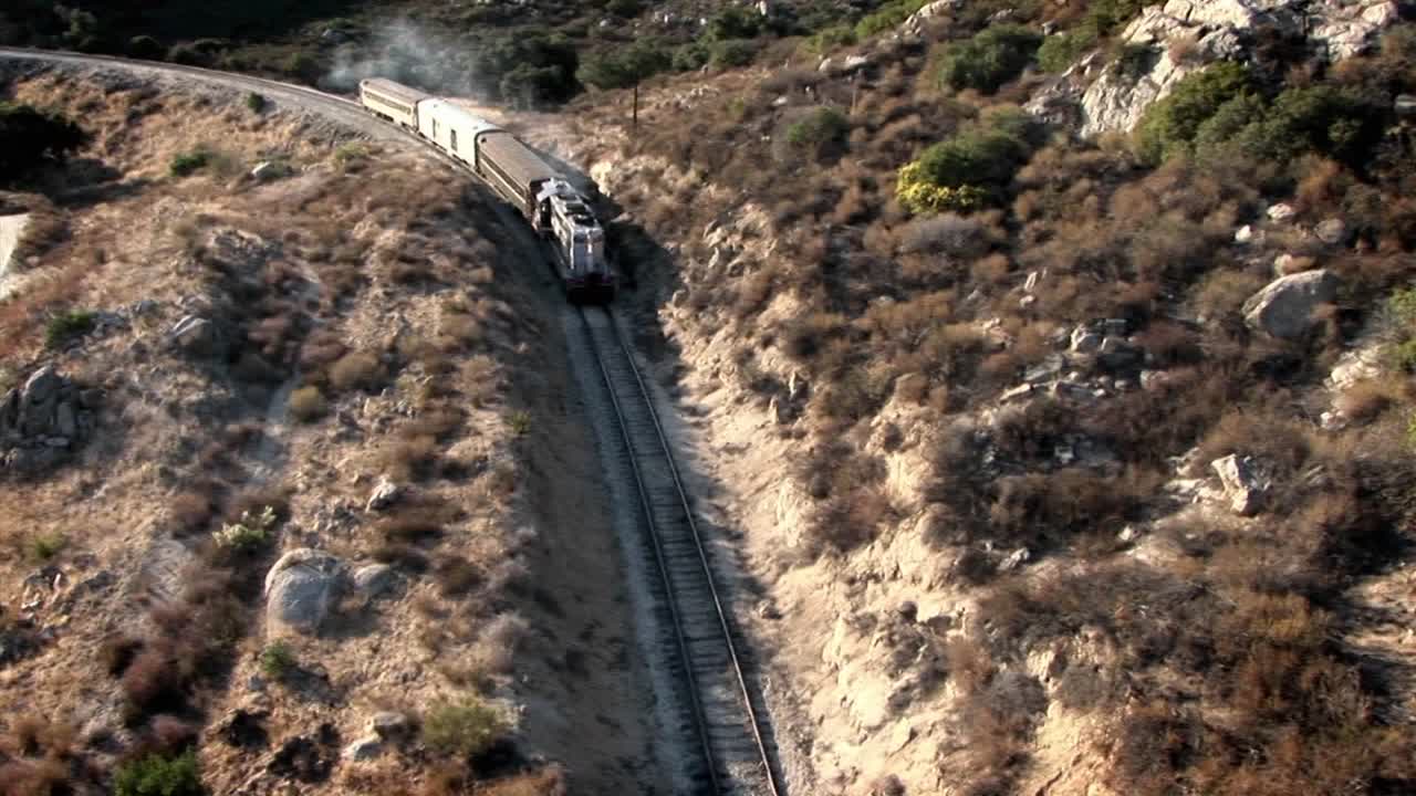 un tren viaja a través de una zona montañosa