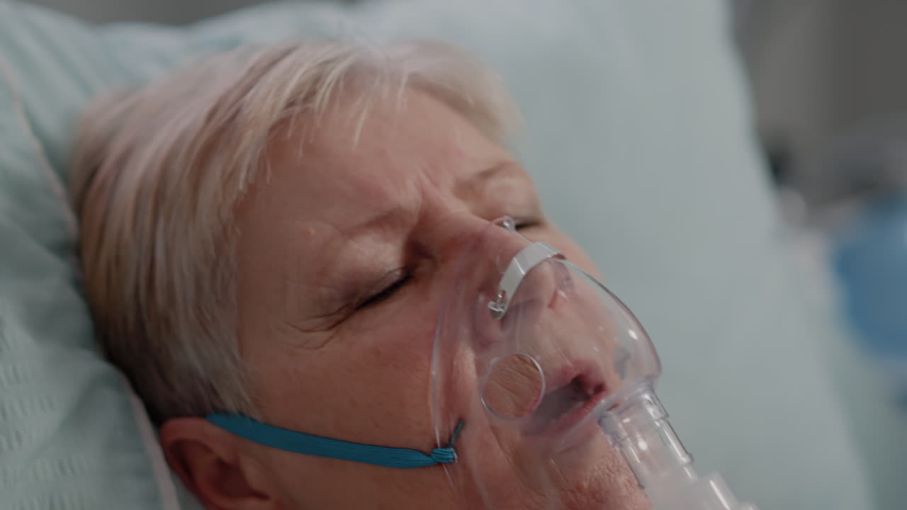 Close up of ill patient having respiratory problem in bed