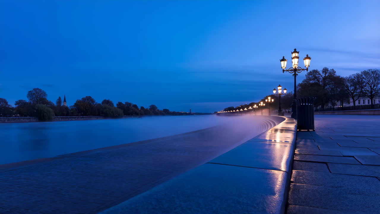 Nighttime River Promenade with Illuminated Streetlights and Reflections