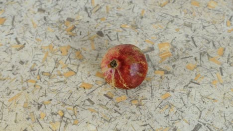 pomegranate close up on light background. view top. camera movement from right to left.