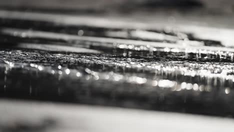 a close-up shot of water flowing over the sand