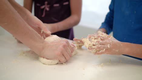 Mother-hand-cooking-with-children.-Mom-cooking-with-kids.-Dough-hands-in-kitchen
