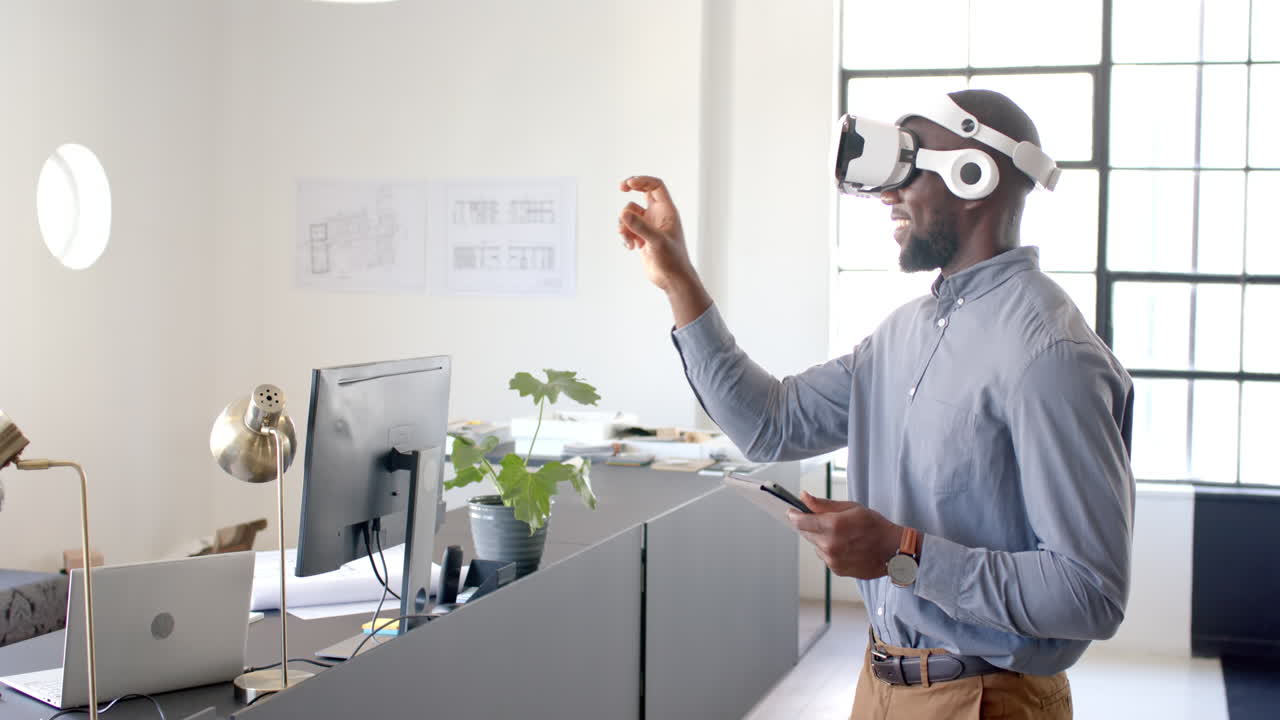 Using VR headset, man interacting with virtual interface in modern office