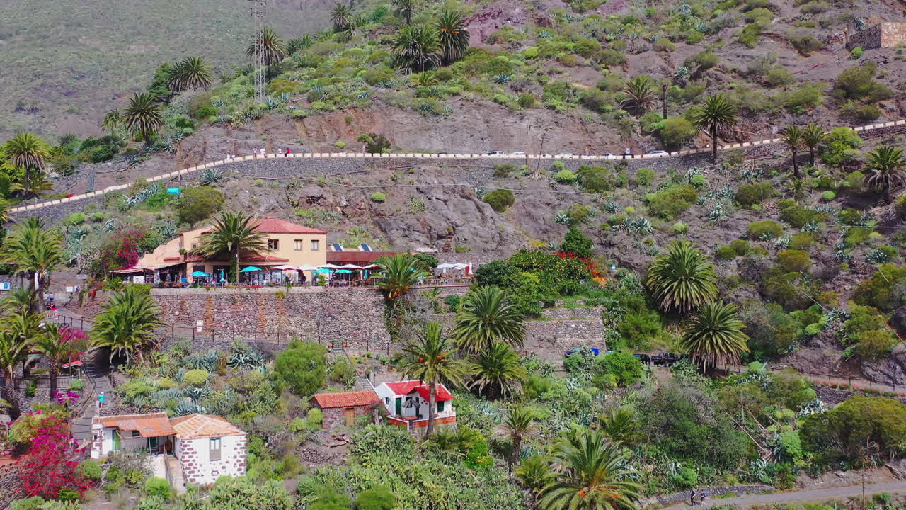 ciudad de masca con caminos y palmeras en un acantilado de montaña empinada, islas canarias, españa