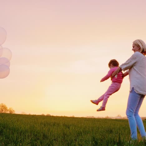 a happy mother of two girls playing with them at sunset