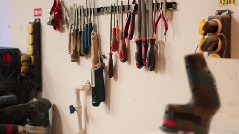 close up of electric router with woodworking tools on rack