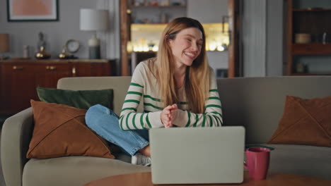 laughing woman enjoy videocall laptop relaxing home. smiling girl video calling