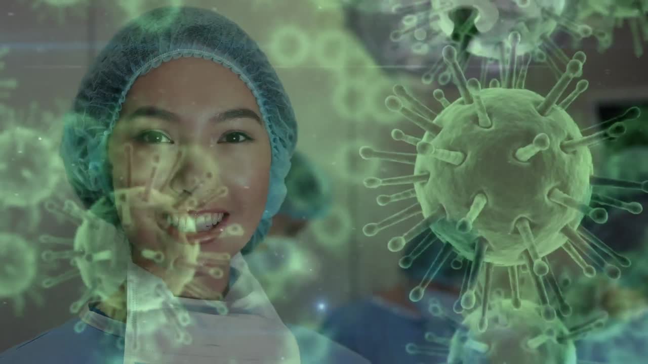 Animation of covid 19 cells over smiling biracial female surgeon in operating theatre