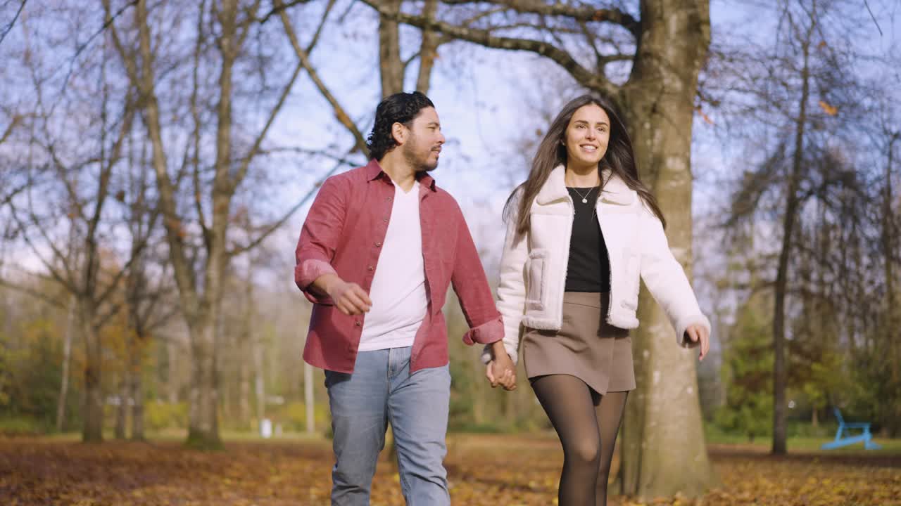 A husband and wife walking through a park in port coquitlam