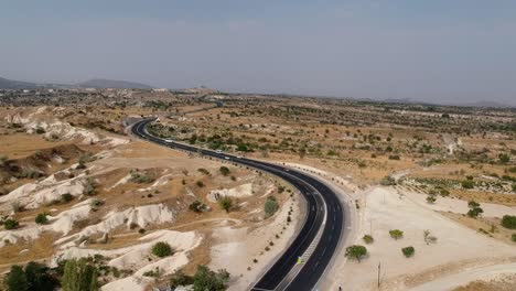 cappadocia turkey desert sandy road sunny terrain curved highway aerial descending view