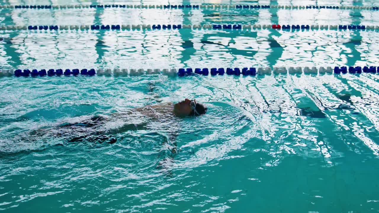 A Swimmer Floating Gracefully in a Crystal-Clear Pool, Showcasing Serenity and Skill in Water, Captured in a Moment of Peaceful Relaxation and Free Movement