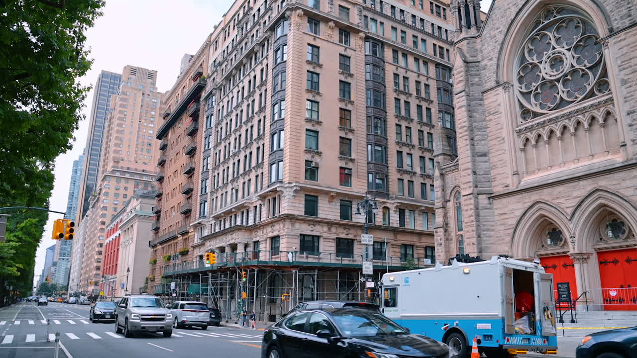 New York, USA, 4 August 2025: Street view with historic church and skyscrapers in Manhattan. Busy avenue with church, traffic, and tall buildings