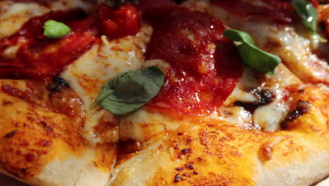 Traditional-Italian-spicy-pepperoni-pizza-with-cherry-tomatoes-and-fresh-basil-leaves,-perfect-crust,-real-authentic-Neapolitan-pizza,-tasty-food,-4K-shot