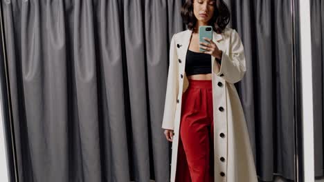 woman trying on clothes in a fitting room