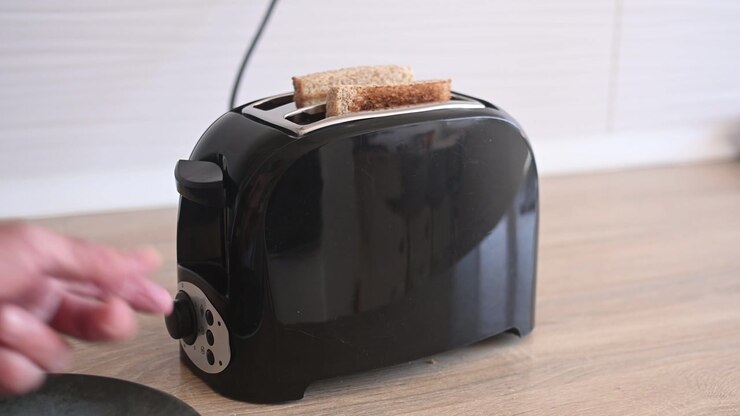 Preparing toast for breakfast in the kitchen