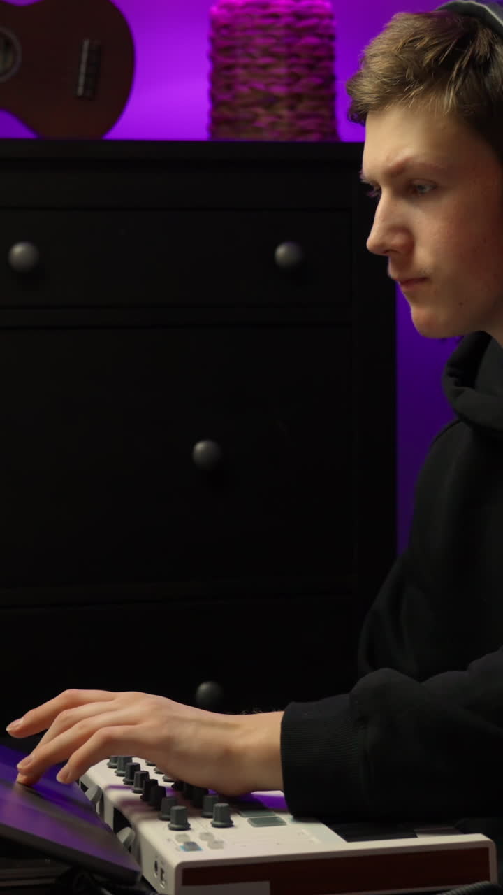 Person making music in home studio with focused expression