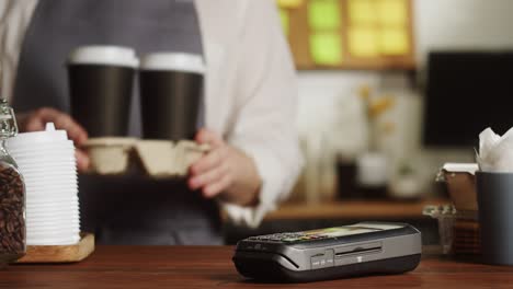 paying with smartwatch in cafe. contactless, touch-free shopping in pubs. nfc technology concept, using fitness bracelet payment via terminal close-up.