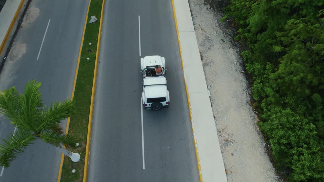 Drone shot view of white cars driving on road in Tulum city, Mexico