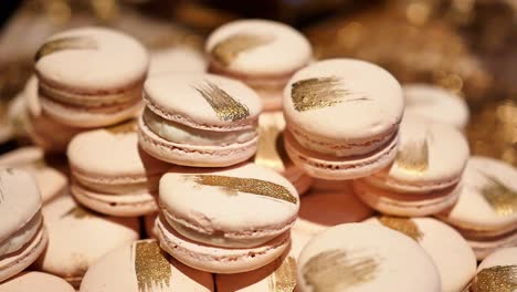 close up, large stack of delicious macarons with golden streaks at wedding party