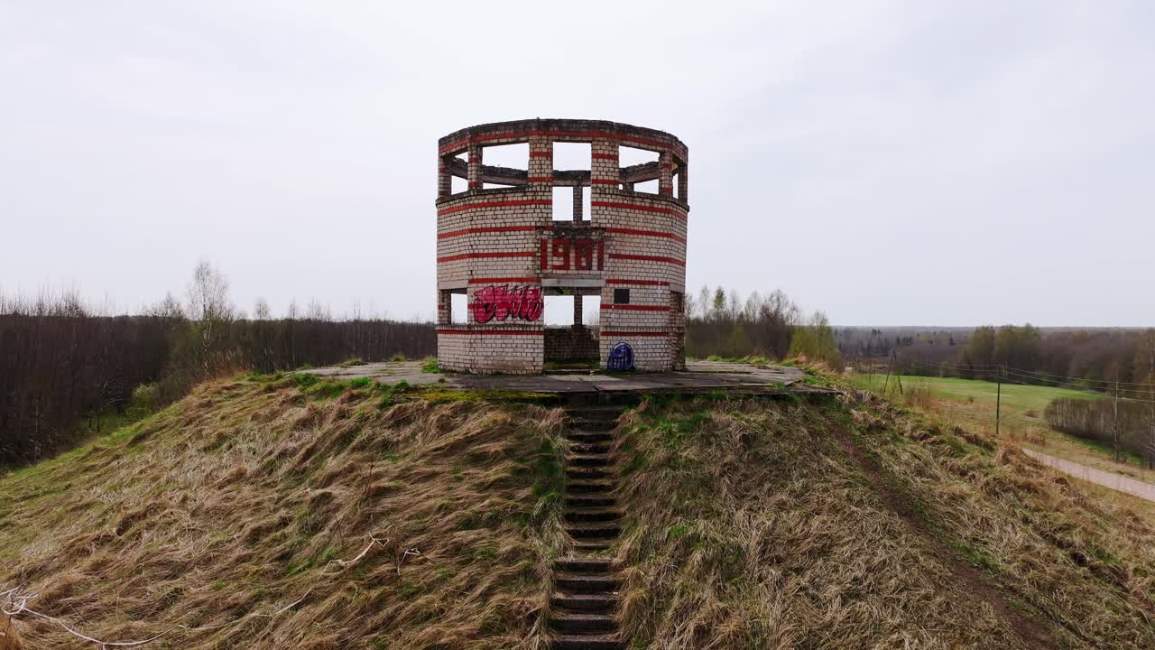Aerial footage brick tower ruins built in 1981 part of old Soviet missile base