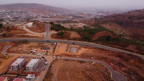 beautiful aerial of a long road in the nigerian countryside with traffic driving peacefully on the street