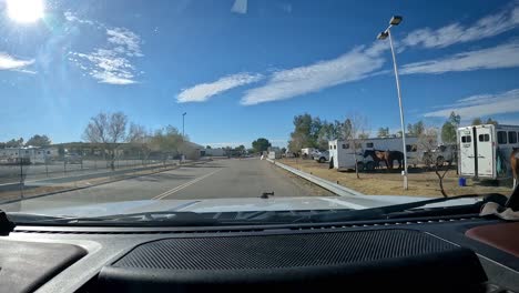 pov - driving between the parking area for the horse trailers and the barrel racing