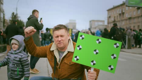 protesting climate activists family. father and son at rally demonstration.