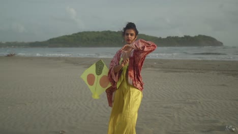 a stunning, captivating asian model, adorned in an elegant yellow and red ensemble, gracefully stands on a picturesque beach