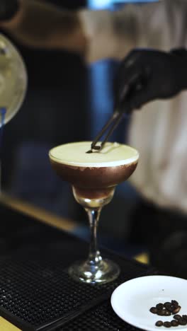 delicate angled closeup vertical shot of sweet coffee crafted drink at hotel bar