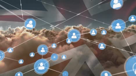 Animation-of-network-of-connections-with-icons-over-flag-of-great-britain-and-clouds
