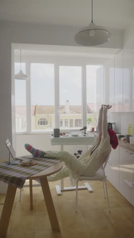 woman relaxing and recording in a cozy kitchen