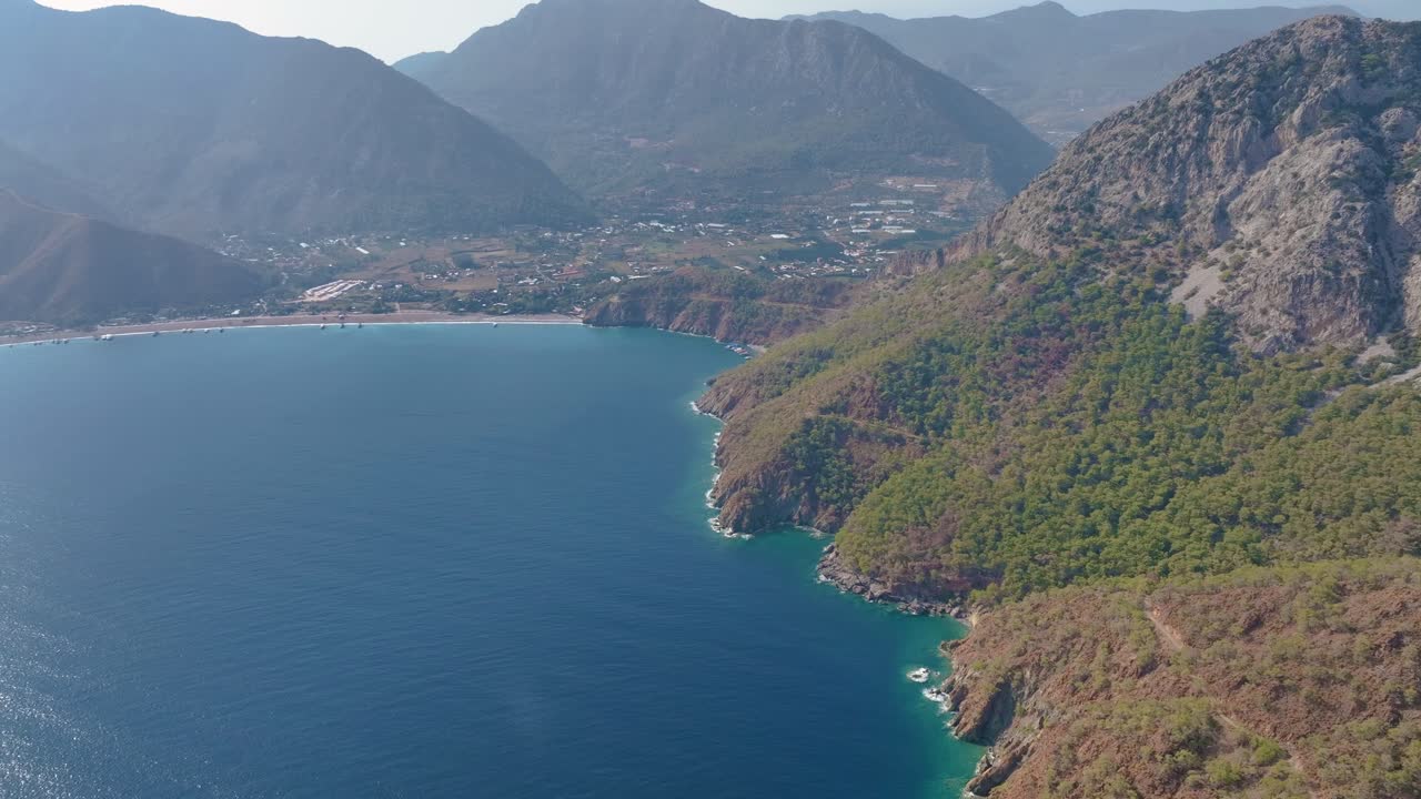 Aerial View of a Coastal Bay with Mountains and Lush Vegetation