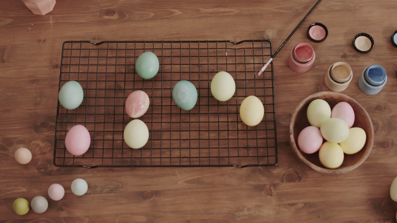 Hand Taking Colored Eggs from Table