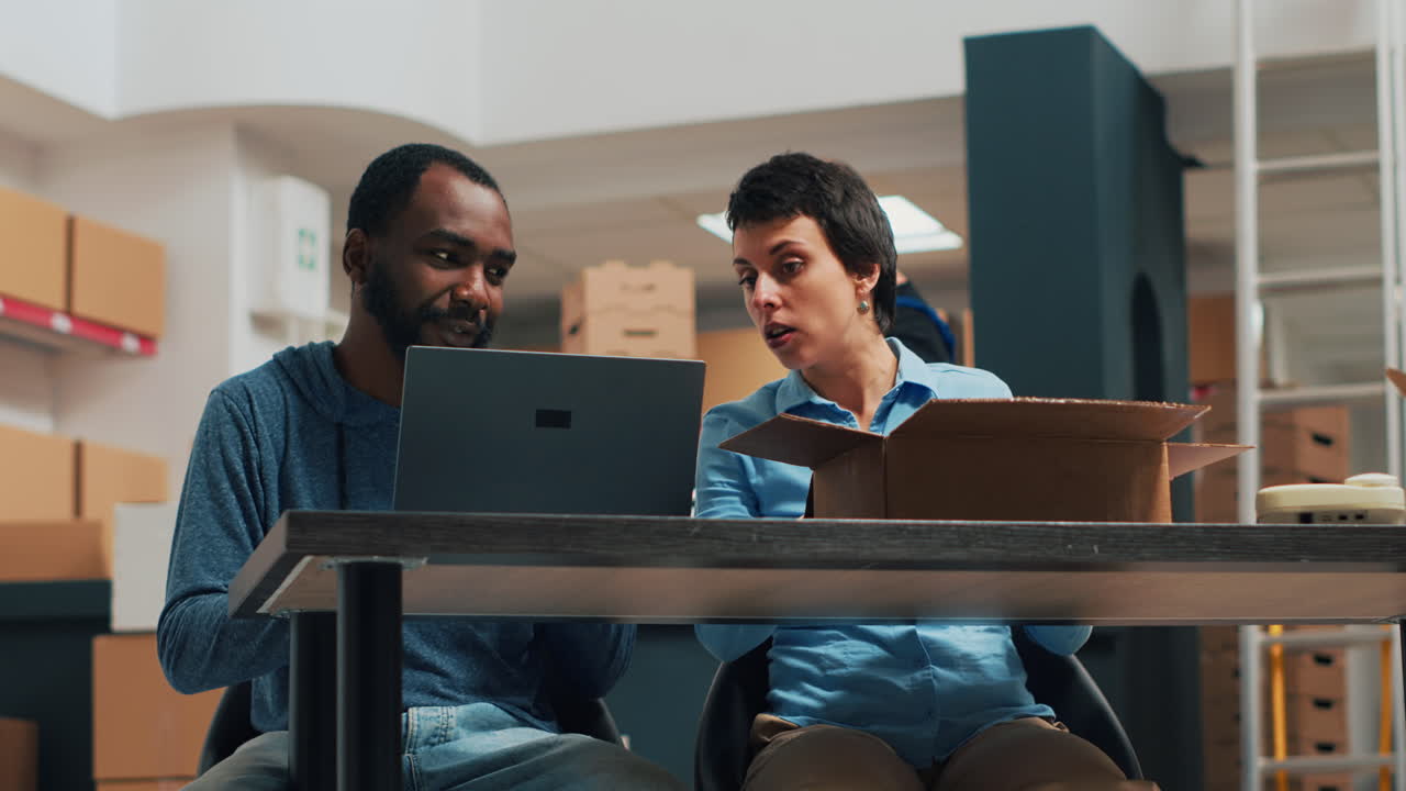 People Working in Warehouse with Boxes and Laptop