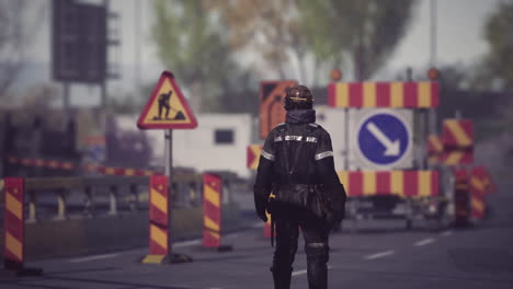 worker managing traffic at construction site during daylight hours