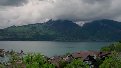 swiss lakeside village under cloudy skies