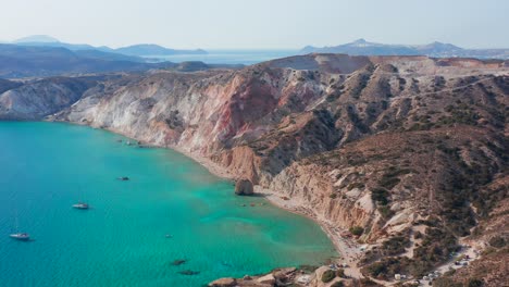 fyriplaka beach aerial panoramic view, pull in drone shot of greek milos island