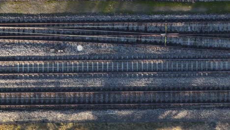 parallel train tracks in swiss landscape - aerial top view