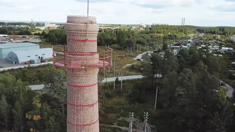 old industrial chimney with metal staircase