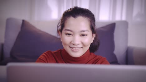 businesswoman on redshirt using the laptop for meeting online and work from home in coronavirus