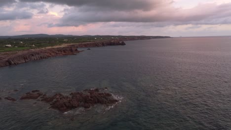 sensational aerial drone view of cliff coastline at sunset, sardinian landscape