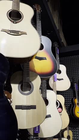 acoustic guitars in a musical instrument store. beautiful multicolored guitars. the concept of stringed musical instruments