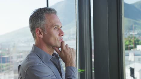 business man thoughtful looking through the window