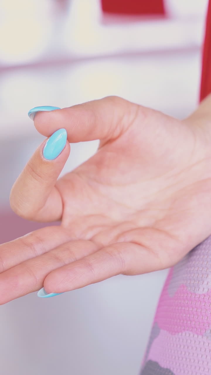 lady hand lie on relaxed woman leg sitting and meditating in butterfly fly yoga asana in hammock extreme close view