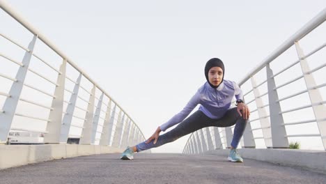 woman wearing hijab stretching outside