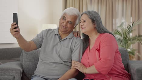 Happy-Indian-old-couple-clicking-selfies